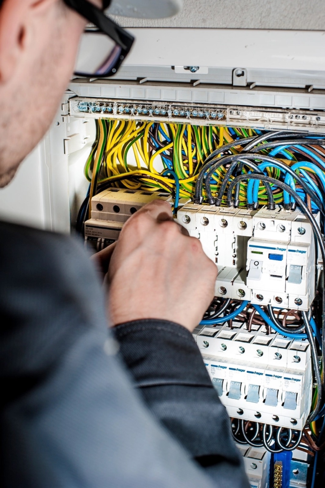 Electrician installing wiring inside a panel to prepare a Port St. Lucie home for storm season