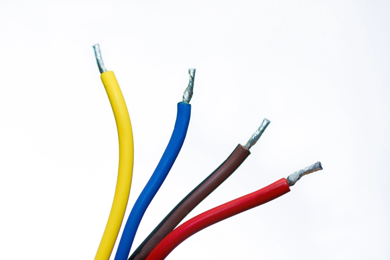 Colorful electrical wiring inside a wall, illustrating signs a home may need rewiring